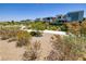 Upscale desert neighborhood with gravel, desert bushes, and walking path in a desert community at 10349 Bressana Dr, Las Vegas, NV 89135