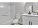 Bathroom with a toilet, vanity, framed mirror, bathtub and tiles at 10373 Midnight Iris St, Las Vegas, NV 89183