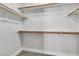 View of a walk-in closet with multiple shelves and rods for ample storage space at 10373 Midnight Iris St, Las Vegas, NV 89183