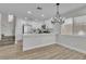Open concept kitchen and dining area with staircase to upper level and modern lighting at 10373 Midnight Iris St, Las Vegas, NV 89183