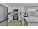 Bright kitchen features white cabinetry, stainless steel appliances, and solid surface countertops at 10373 Midnight Iris St, Las Vegas, NV 89183