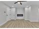 Modern living area with electric fireplace, two interior doors and wood flooring at 10373 Midnight Iris St, Las Vegas, NV 89183