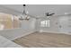 Spacious living room with modern lighting and beautiful wood-look floors at 10373 Midnight Iris St, Las Vegas, NV 89183