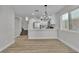 Open concept living area featuring updated kitchen and staircase to upper level at 10373 Midnight Iris St, Las Vegas, NV 89183