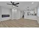 Open concept living area with an electric fireplace and access to a modern kitchen at 10373 Midnight Iris St, Las Vegas, NV 89183
