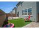 Backyard featuring patio with furniture and synthetic grass, offering a relaxing retreat at 10630 Adobe Ranch St, Las Vegas, NV 89141