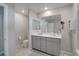 Well-lit bathroom featuring a double sink vanity, ample counter space, toilet, and modern fixtures at 10630 Adobe Ranch St, Las Vegas, NV 89141