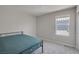 Bright bedroom with neutral colored walls, carpet flooring, and a window allowing plenty of natural light at 10630 Adobe Ranch St, Las Vegas, NV 89141