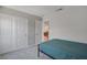Simple bedroom with neutral carpeting, a window for natural light, and a double door closet for plenty of storage at 10630 Adobe Ranch St, Las Vegas, NV 89141