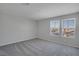 This bedroom provides ample space, carpeted floors, and a bright, inviting atmosphere with natural light at 10630 Adobe Ranch St, Las Vegas, NV 89141