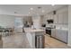 Eat-in kitchen boasts stainless steel appliances, a center island, and stylish gray cabinets with lots of storage at 10630 Adobe Ranch St, Las Vegas, NV 89141