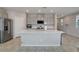 Spacious kitchen features an oversized kitchen island, stainless steel appliances, and tile flooring at 10630 Adobe Ranch St, Las Vegas, NV 89141