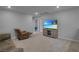 Cozy living room with a plush recliner, comfortable sofa, and large flat-screen television for entertainment at 10630 Adobe Ranch St, Las Vegas, NV 89141