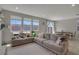 Cozy living area offers lots of natural light from large windows and access to dining area at 10630 Adobe Ranch St, Las Vegas, NV 89141