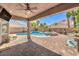 Relaxing backyard featuring a pool, spa, covered patio, and brick pavers at 11219 Playa Bonita Ave, Las Vegas, NV 89138