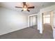 Bright bedroom featuring neutral tones, a ceiling fan, and a mirrored sliding door closet at 11219 Playa Bonita Ave, Las Vegas, NV 89138