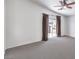 Large bedroom with neutral carpet, ceiling fan, and sliding glass door to a private balcony at 11219 Playa Bonita Ave, Las Vegas, NV 89138