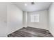 Bedroom featuring hardwood flooring, a window for natural light, and crisp neutral paint at 11219 Playa Bonita Ave, Las Vegas, NV 89138