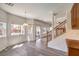 Bright dining area with grey wood floors, windows with pool views, and a staircase at 11219 Playa Bonita Ave, Las Vegas, NV 89138