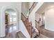 Bright foyer with high ceilings, staircase with wood railing, and grey wood floors at 11219 Playa Bonita Ave, Las Vegas, NV 89138