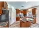 Updated kitchen with granite countertops, stainless steel appliances, and wood cabinets at 11219 Playa Bonita Ave, Las Vegas, NV 89138