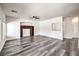Spacious living room featuring built-in shelves, fan and grey wood floors at 11219 Playa Bonita Ave, Las Vegas, NV 89138