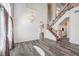Bright living room with high ceilings, grey wood floors, window, chandelier and staircase at 11219 Playa Bonita Ave, Las Vegas, NV 89138