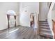 Bright living room with high ceilings, grey wood floors, window, chandelier and staircase at 11219 Playa Bonita Ave, Las Vegas, NV 89138