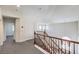 Upper loft with carpet and wood railing, showcasing the home's open floor plan and neutral finishes at 11219 Playa Bonita Ave, Las Vegas, NV 89138
