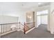Bright loft area featuring carpet, wood railing, and neutral color scheme for a cozy, adaptable space at 11219 Playa Bonita Ave, Las Vegas, NV 89138