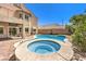Backyard with a pool, hot tub, and a balcony above a covered patio at 11219 Playa Bonita Ave, Las Vegas, NV 89138