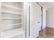 Walk-in closet with built-in shelves and neutral walls at 1440 Vegas Valley Dr # 13, Las Vegas, NV 89169