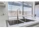 Stainless steel sink in a kitchen featuring a window, neutral walls, and white quartz countertops at 1440 Vegas Valley Dr # 13, Las Vegas, NV 89169