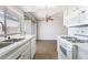Open-concept kitchen featuring stainless appliances, white cabinetry, and hardwood floors at 1440 Vegas Valley Dr # 13, Las Vegas, NV 89169