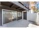 Private patio with sliding glass door, a small window, and a fenced-in yard space at 1440 Vegas Valley Dr # 13, Las Vegas, NV 89169