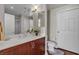 Well-lit bathroom with vanity featuring dark wood cabinets, quartz countertop, and white tiled shower at 150 Las Vegas Blvd # 1906, Las Vegas, NV 89101