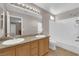 This bathroom has double sinks and a shower over the tub at 1553 Ivygate Ave, Las Vegas, NV 89183