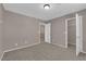 This carpeted bedroom has closet space and an ensuite bathroom at 1553 Ivygate Ave, Las Vegas, NV 89183
