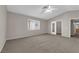 Large main bedroom includes ceiling fan, carpet, and ensuite bathroom at 1553 Ivygate Ave, Las Vegas, NV 89183