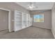 This carpeted bedroom has natural light and built in shelving at 1553 Ivygate Ave, Las Vegas, NV 89183