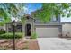 Charming two-story home with a two-car garage, landscaped front yard, inviting porch and red front door at 1553 Ivygate Ave, Las Vegas, NV 89183