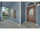 Inviting front porch featuring blue siding, brown door with a 'Welcome' sign and arched window at 1553 Ivygate Ave, Las Vegas, NV 89183