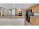 Bright kitchen featuring wood cabinets, black appliances, tile flooring and granite countertops at 1553 Ivygate Ave, Las Vegas, NV 89183