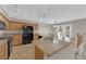 Open kitchen featuring wood cabinets, black appliances and granite countertops at 1553 Ivygate Ave, Las Vegas, NV 89183
