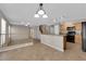 Open floor plan showing living room and kitchen with natural light from large windows and sliding doors at 1553 Ivygate Ave, Las Vegas, NV 89183