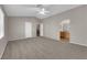 Spacious carpeted main bedroom with ceiling fan and ensuite bathroom entrance at 1553 Ivygate Ave, Las Vegas, NV 89183