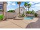 A relaxing pool area with a spa and mature palm trees in the backyard at 1553 Ivygate Ave, Las Vegas, NV 89183