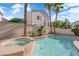 Sparkling backyard pool and spa surrounded by lush palm trees at 1553 Ivygate Ave, Las Vegas, NV 89183