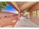 Covered patio featuring desert landscaping and a well-maintained backyard at 1643 Silver Slipper Ave, Henderson, NV 89002