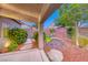 Covered patio with meticulously maintained desert landscaping and mature plants at 1643 Silver Slipper Ave, Henderson, NV 89002